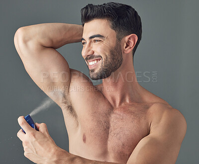 Buy stock photo Shot of a man applying deodorant to his underarms