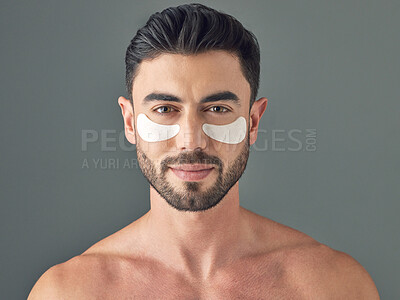 Buy stock photo Studio shot of a handsome young man wearing under-eye patches