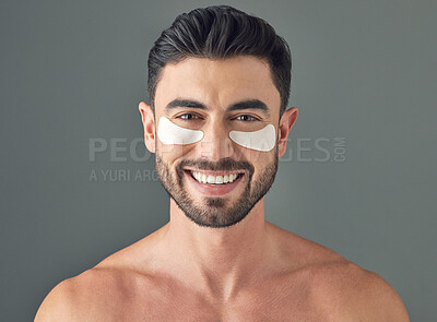 Buy stock photo Studio shot of a handsome young man wearing under-eye patches