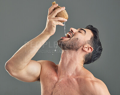 Buy stock photo Studio shot of a man drinking coconut water