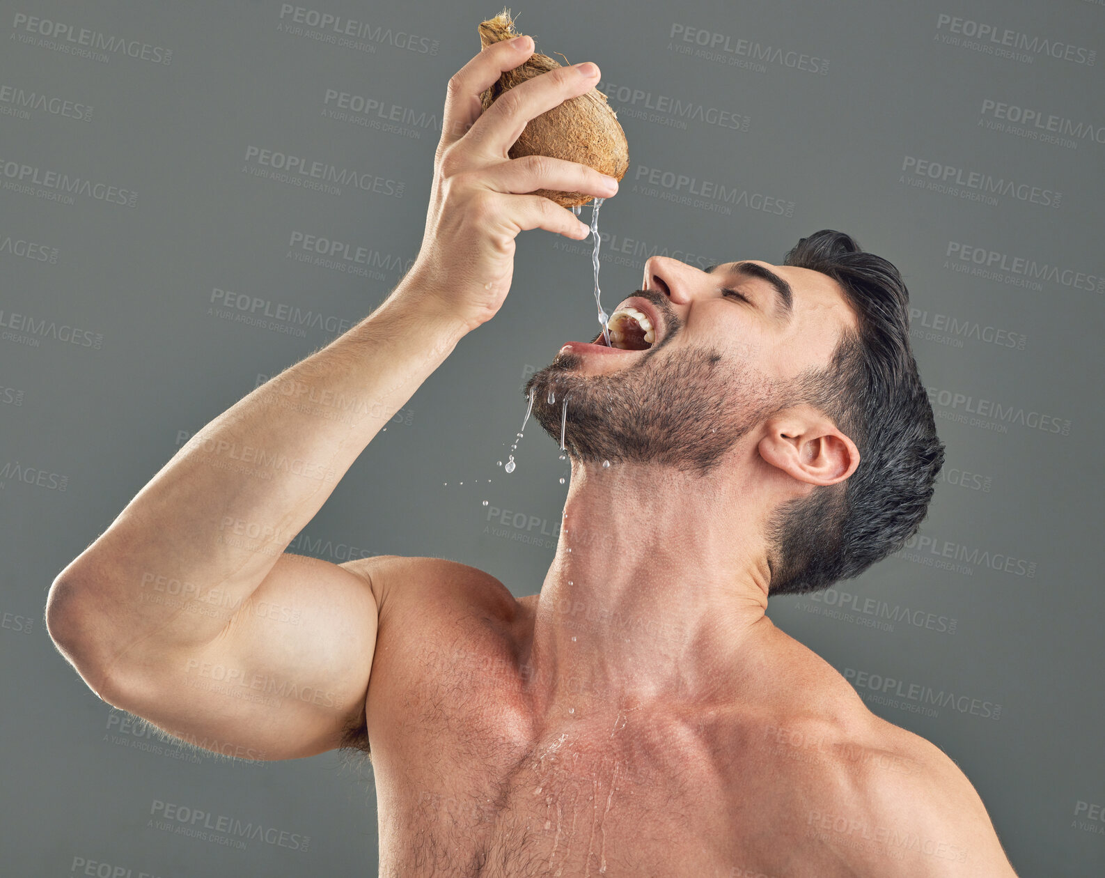 Buy stock photo Studio shot of a man drinking coconut water