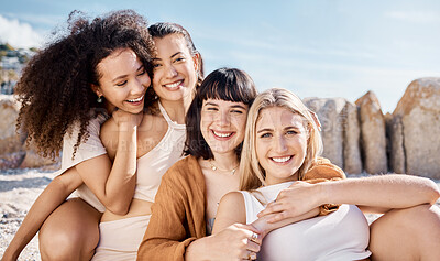 Buy stock photo Shot of a group of female friends spending time together at the beach
