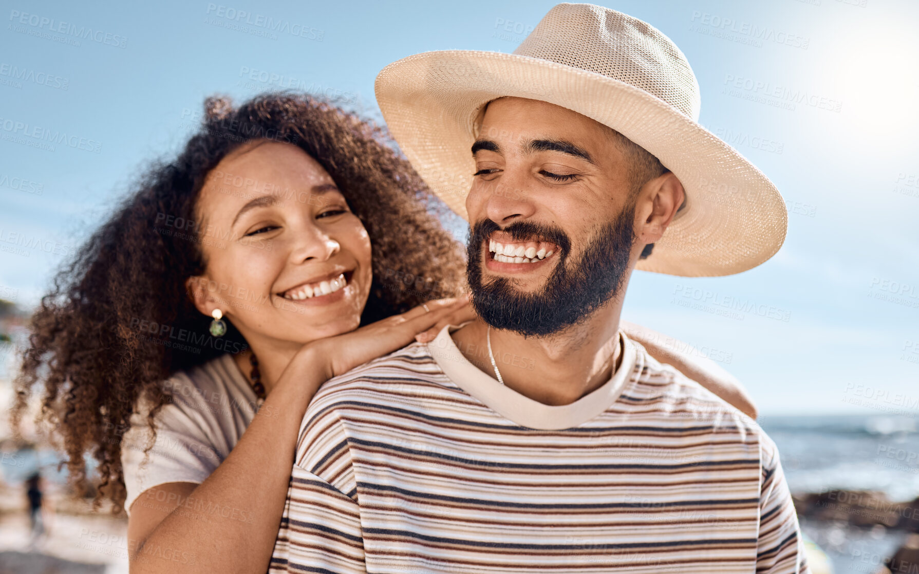 Buy stock photo Shot of a young couple spending time together at the beach