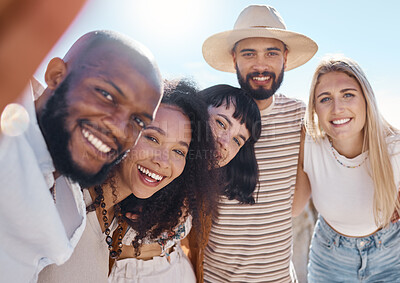 Buy stock photo Shot of a man talking a selfie while at the beach with friends
