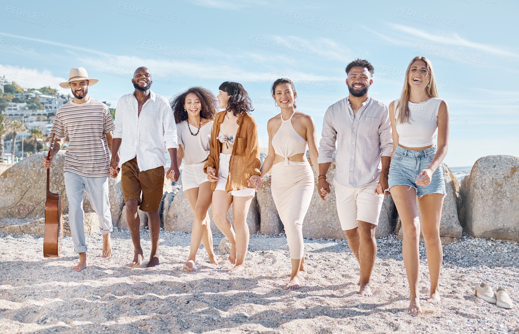 Buy stock photo Shot of a group of friends enjoying their time together at the beach