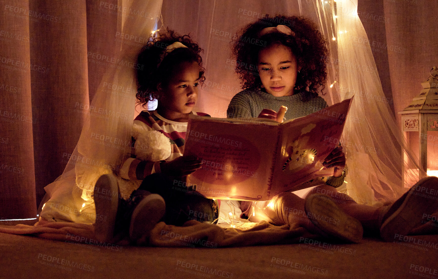 Buy stock photo Children, sisters and reading with book in night, tent and fantasy with learning, bonding and love in home. Girl, siblings and story with toys, relax and connection on bedroom floor in family house