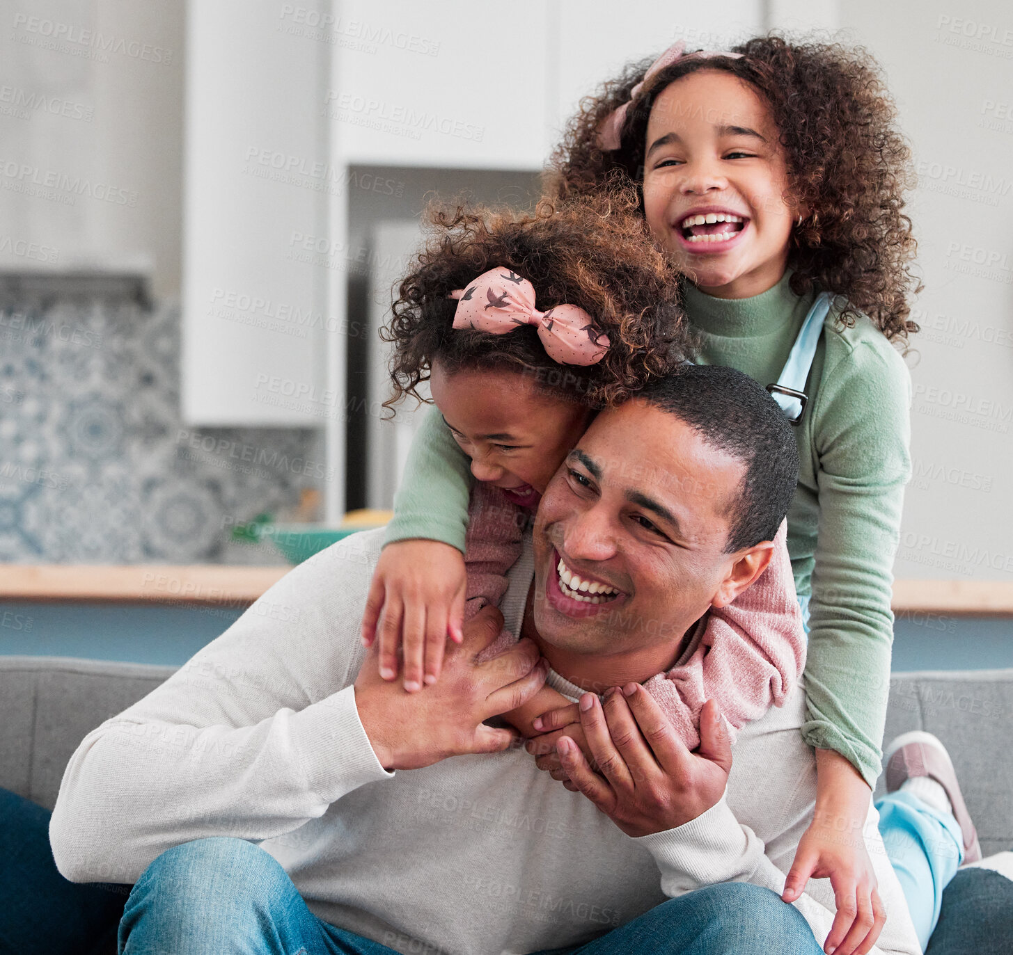 Buy stock photo Father, girl children and laughing on sofa with game, excited and piggy back with connection in lounge. Man, dad and kids with love, happy and playful on couch with holding hands at family house