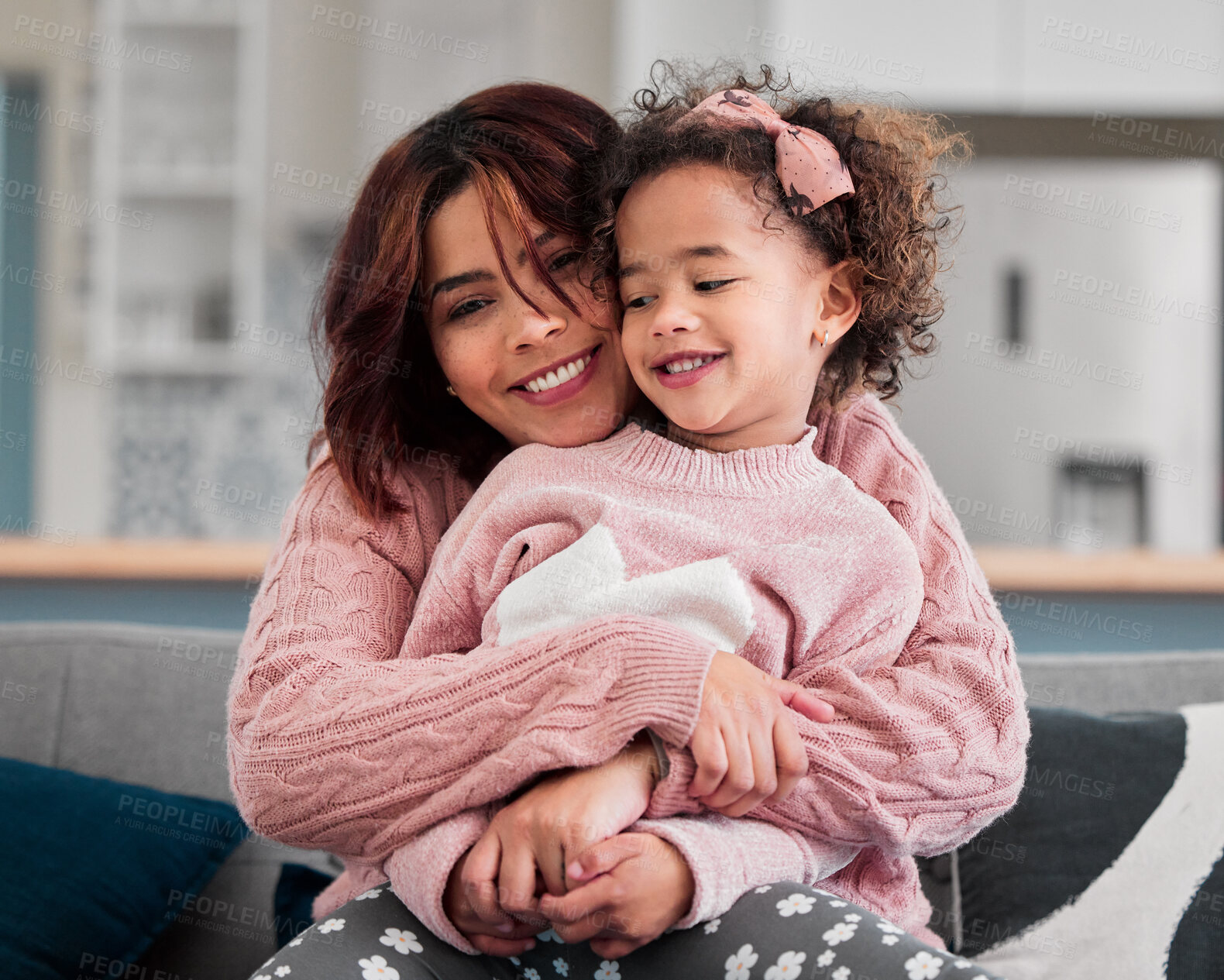 Buy stock photo Happy mom, hug and love with child on sofa for embrace, care or support together at home. Young mom, little girl and daughter with smile for bonding, childhood youth or mothersday on couch at house