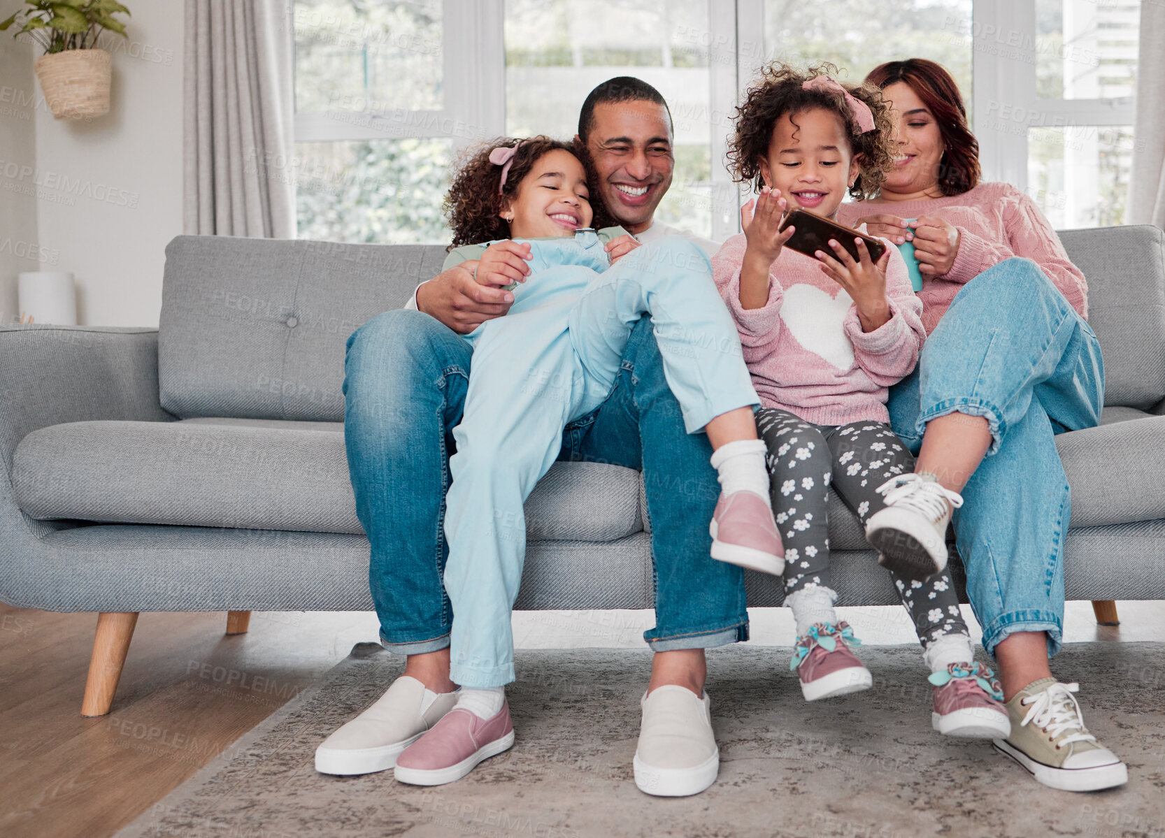 Buy stock photo Phone, relax and family on sofa in home playing educational game online for childhood development. Happy, love and kids resting with parents on cellphone with learning video for growth in house