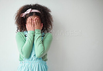 Buy stock photo Cover eyes, girl and kid with fear, shy and afraid with reaction on gray studio background. Model, mockup space and childhood with hands on face, hide and seek with game, surprise and blind emoji