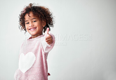 Buy stock photo Thumbs up, child or portrait on studio space for yes, approval or happy for agreement. Girl, hand gesture or smile on white background for choice, thank you or appreciation with positivity in Brazil