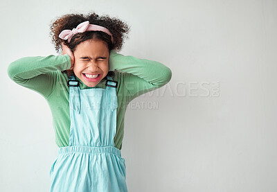 Buy stock photo Loud, studio and child cover ears by mockup space for sound with ADHD, scared or autism spectrum. Neurodivergent, anxiety and girl kid with noise blocking for sensory sensitivity by white background.