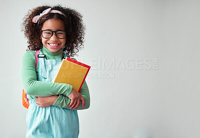 Buy stock photo School, portrait of child student with books for knowledge, education and studying in a studio. Happy, smile and young smart girl kid with glasses for reading by a white background with mockup space.