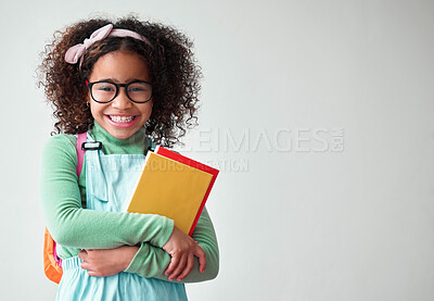 Buy stock photo Education, smart and portrait a child with books for knowledge, reading and studying in a studio. Happy, smile and young girl kid student with glasses isolated by a white background with mockup space