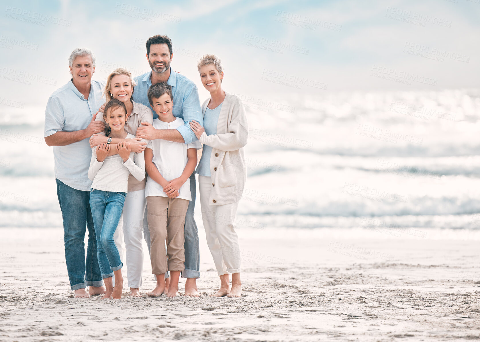 Buy stock photo Hug, portrait and smile with family on beach together for holiday, travel or vacation. Love, mockup space or summer with senior people, parents and sibling children outdoor for bonding or wellness