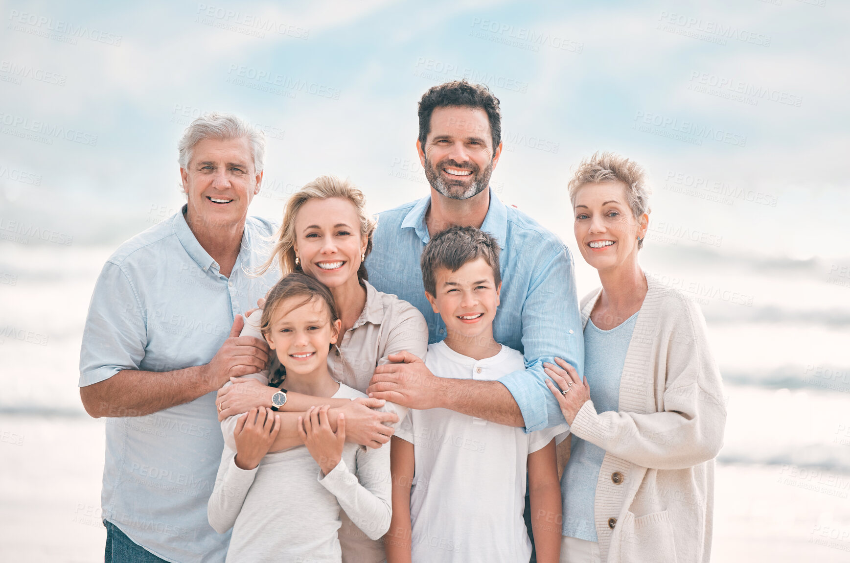 Buy stock photo Hug, portrait and smile with big family on beach together for holiday, travel or vacation. Embrace, love or summer with senior people, parents and sibling children outdoor for bonding or wellness