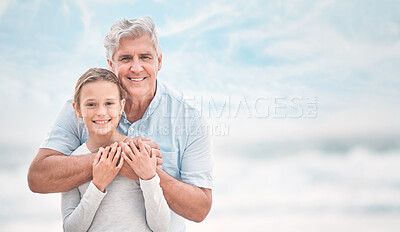 Buy stock photo Shot of a mature man and his granddaughter bonding at the beach