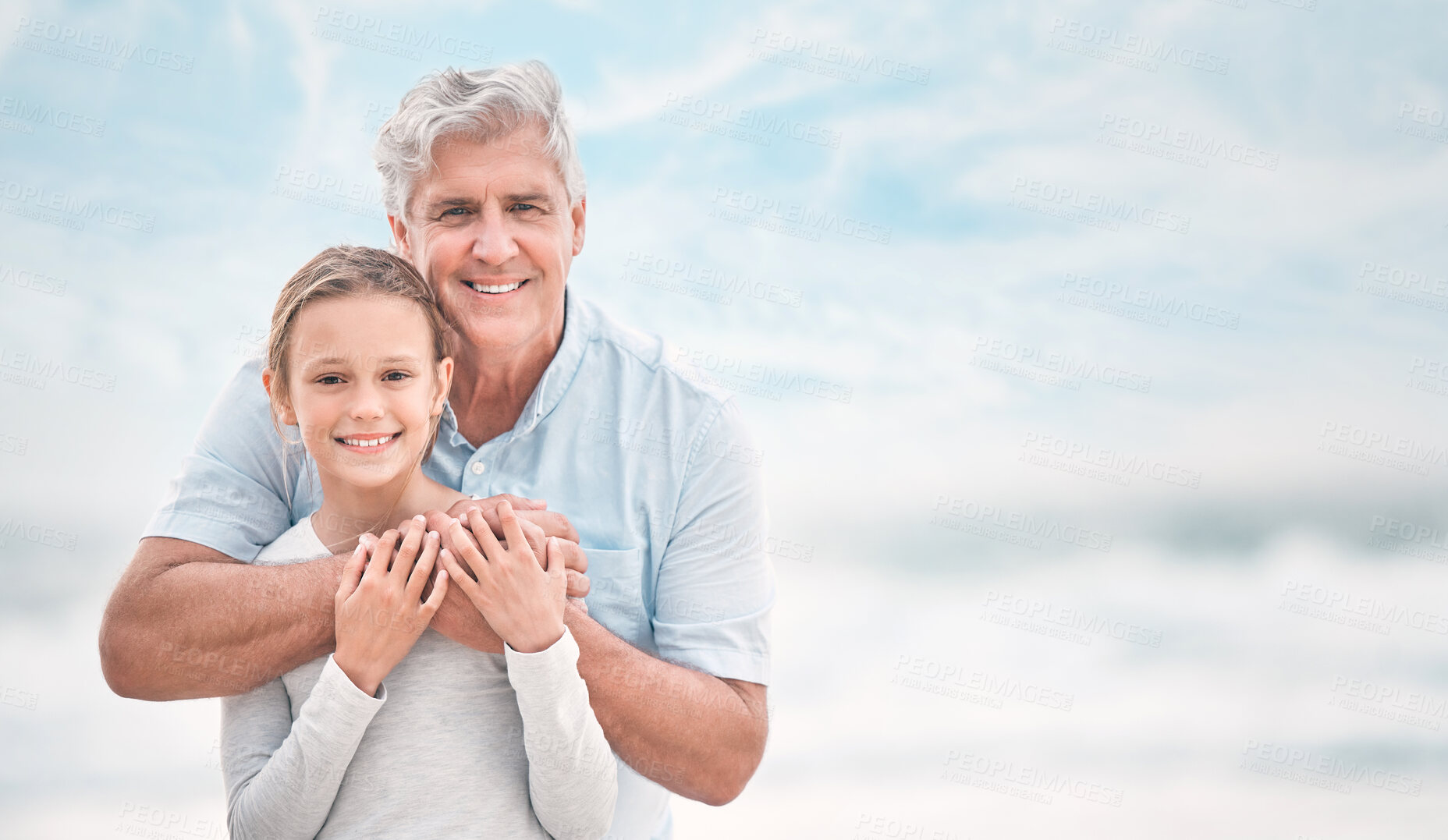 Buy stock photo Hug, portrait and girl with grandfather on beach together for holiday, travel or vacation. Love, smile or summer with old man and happy grandkid embracing outdoor on blue sky for bonding or wellness