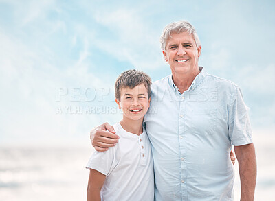 Buy stock photo Hug, portrait and boy with grandfather on beach together for holiday, travel or vacation. Love, space or support with smile of senior man and grandson embracing outdoor for bonding or wellness