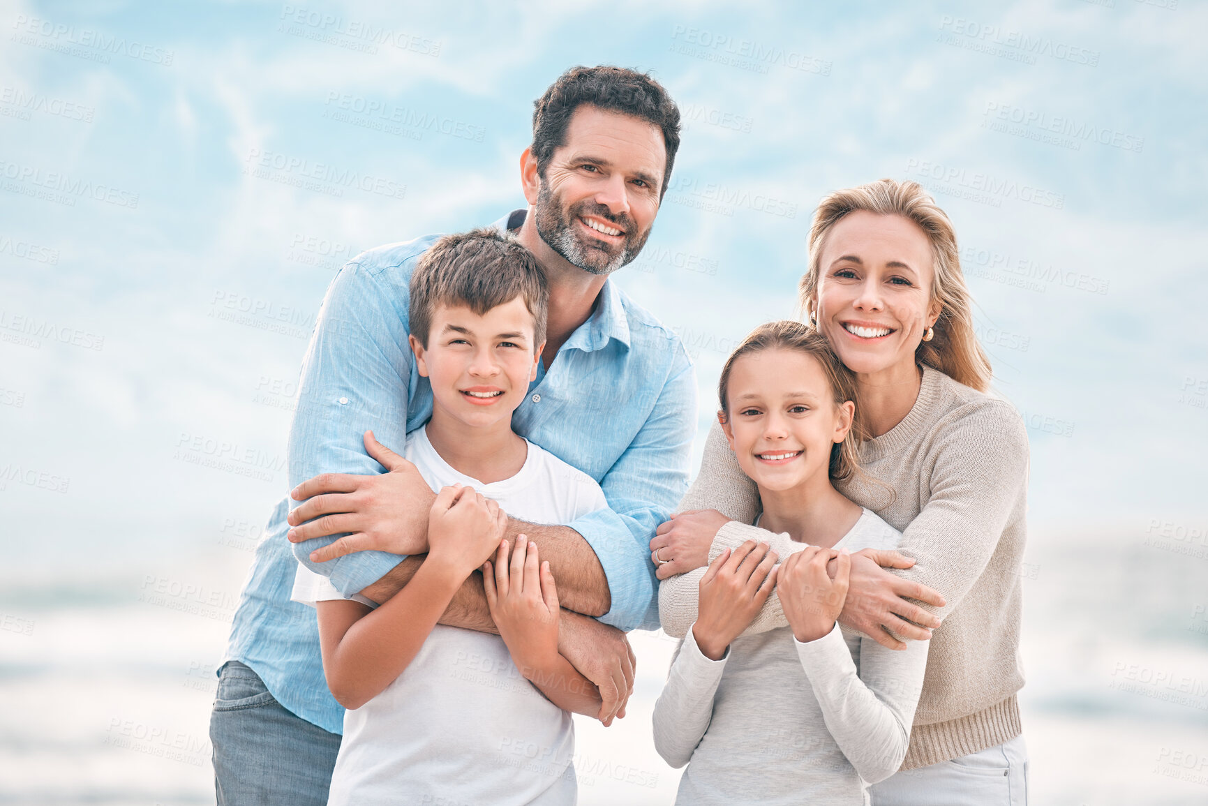 Buy stock photo Hug, portrait and support with happy family on beach together for holiday, travel or vacation. Love, smile or wellness with mother, father and sibling children embracing outdoor for summer bonding