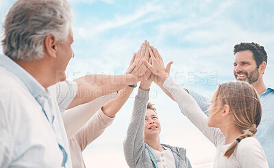 Buy stock photo Shot of a beautiful family sharing high-five while bonding at the beach