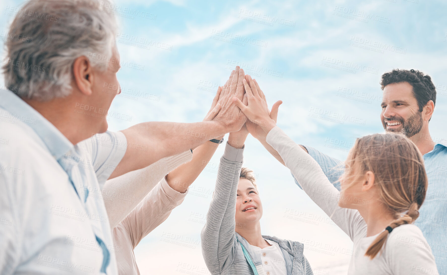 Buy stock photo High five, motivation and support with family on beach together for holiday, travel or vacation in summer. Smile, sky or success with senior people, parents and kids on coast for tropical getaway