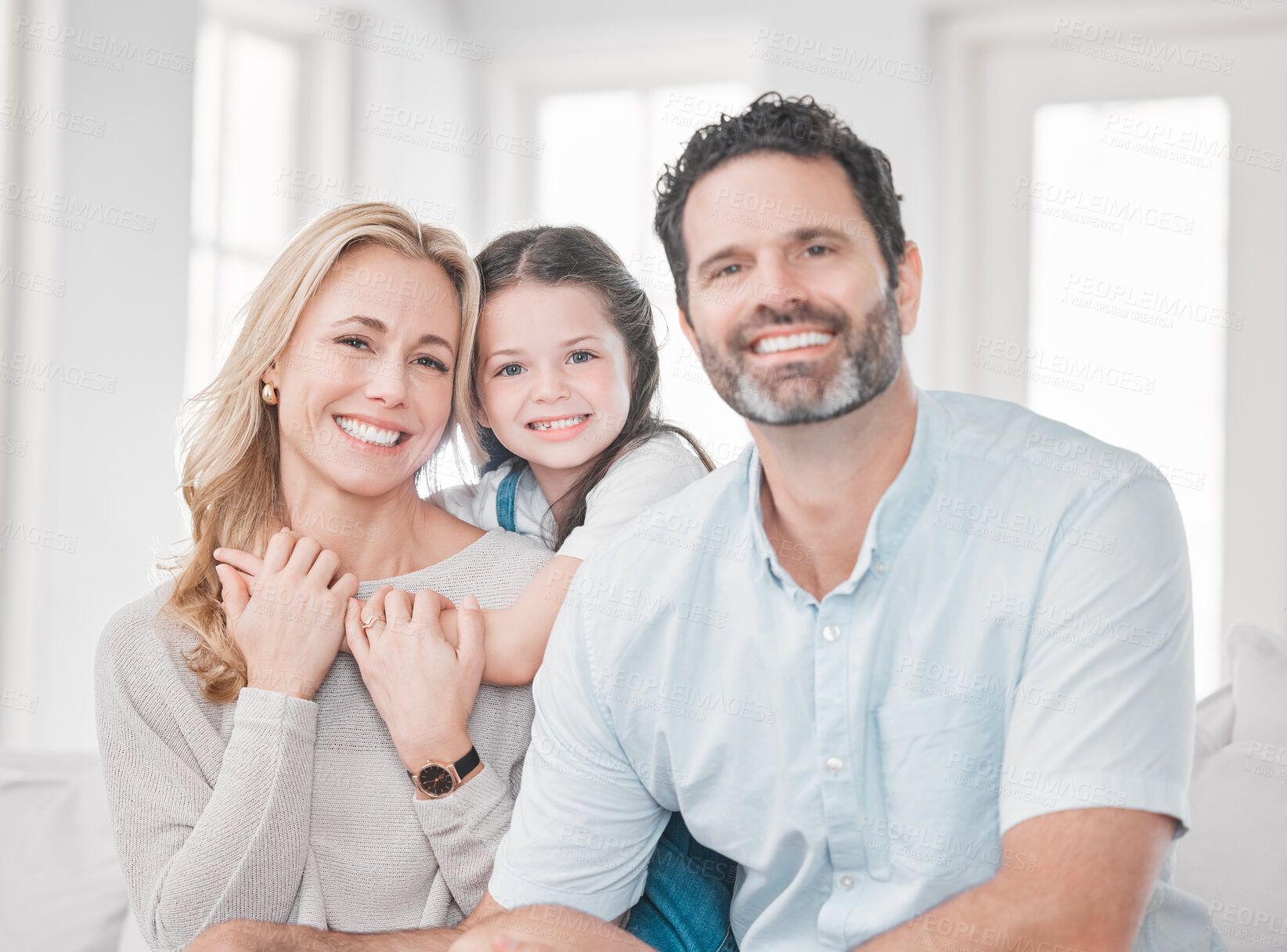 Buy stock photo Family, love and relax on sofa together for quality time or relationship bonding in family home. Happy family portrait, parents support and relaxing hug with smiling young child on couch at home