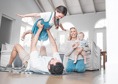 Buy stock photo Happy family play on living room floor, airplane game with girl  child and father lifting kid in Houston home. Parents enjoy fun weekend with children, laughing together in lounge and trust dad