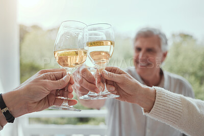 Buy stock photo Shot of an elderly man toasting with unrecognizable family memers at home
