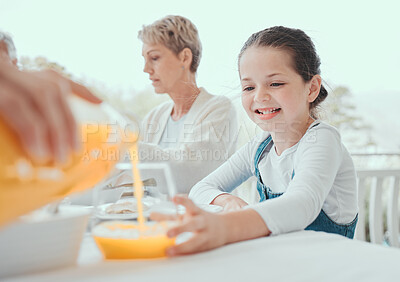 Buy stock photo Shot of a little girl getting some juice from a family member at home