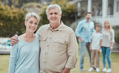 Buy stock photo Hug, portrait and smile of old couple in garden of new home with family for property investment. Development, love or partnership and senior people with children and grandkids for real estate growth