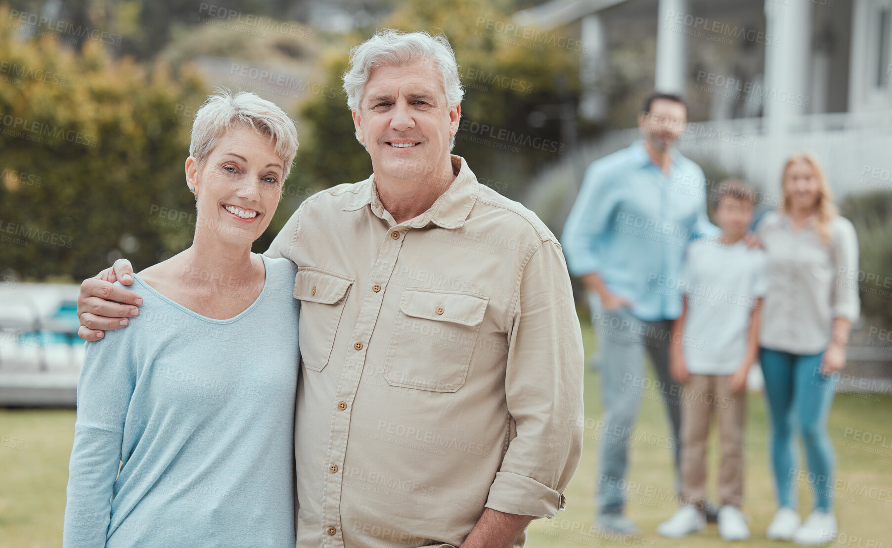 Buy stock photo Hug, portrait and smile of old couple in garden of new home with family for property investment. Development, love or partnership and senior people with children and grandkids for real estate growth