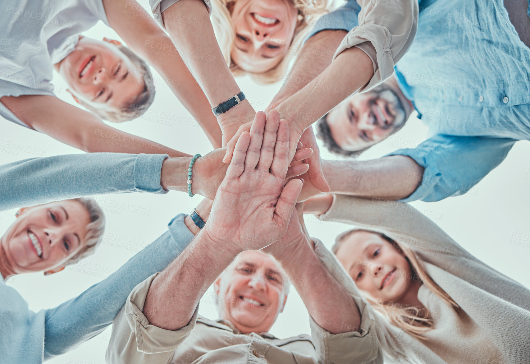 Buy stock photo Happy family, portrait and hands together for teamwork, agreement or collaboration in solidarity. Below group and people in community gathering for unity, motivation celebration or love with blue sky