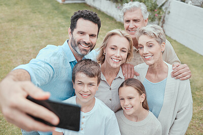 Buy stock photo Shot of a family taking a selfie in the garden at home