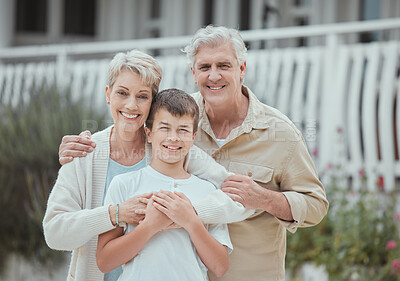 Buy stock photo Shot of a grandchild spending time with his grandparents at home