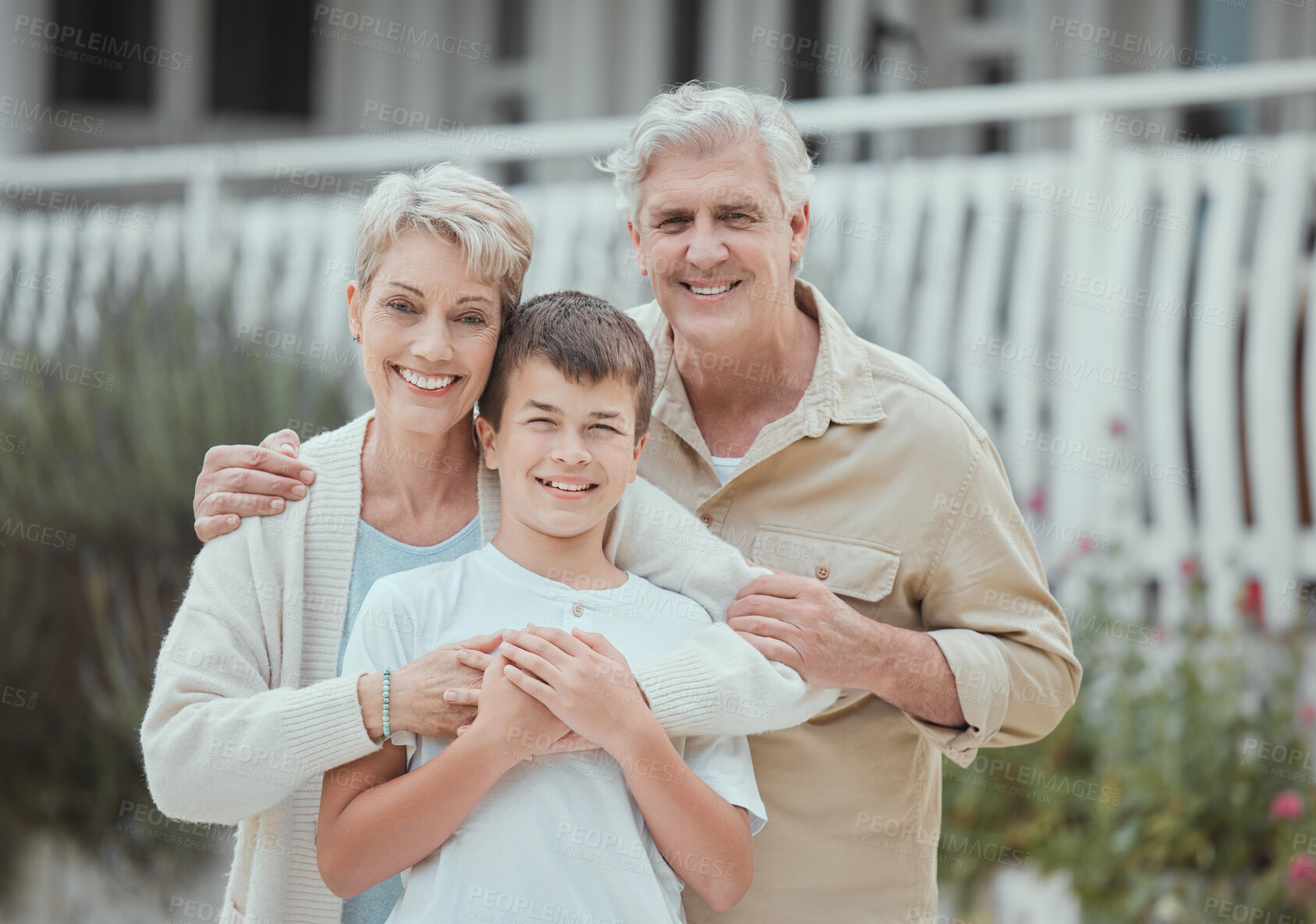 Buy stock photo Shot of a grandchild spending time with his grandparents at home