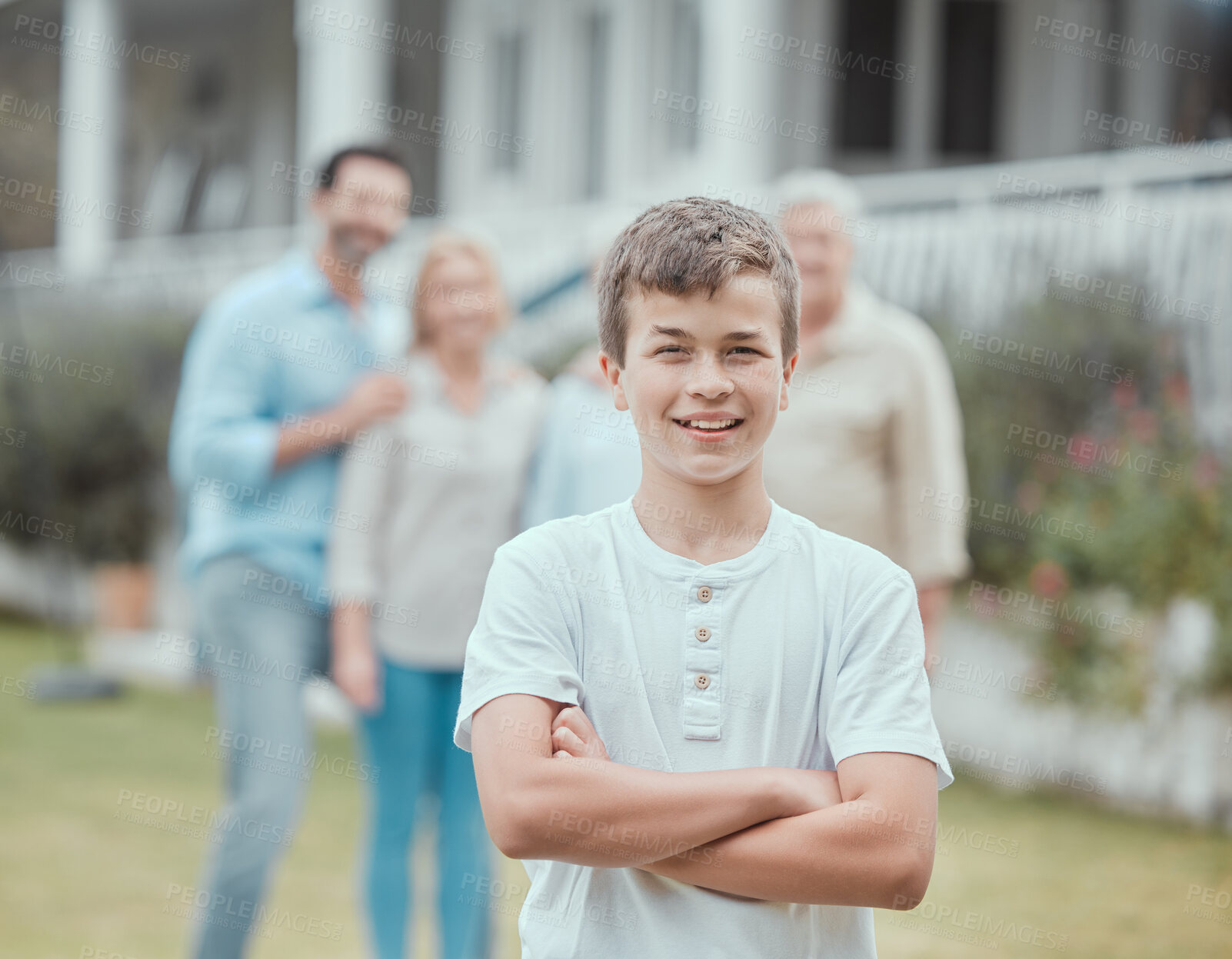 Buy stock photo Arms crossed, portrait and smile of boy in garden of new home with family for property investment. Child development, confident and son outdoor with senior people and parents for real estate growth