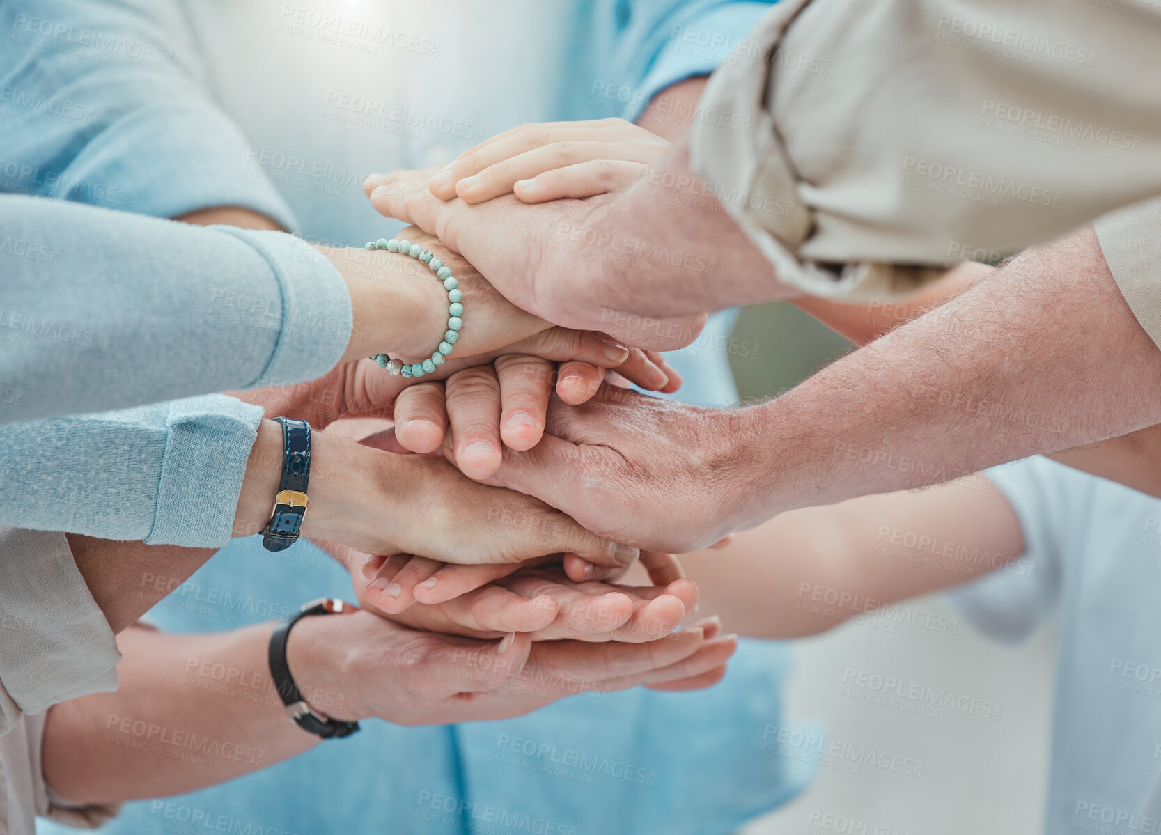 Buy stock photo Shot of a family stacking their hands in the garden outside