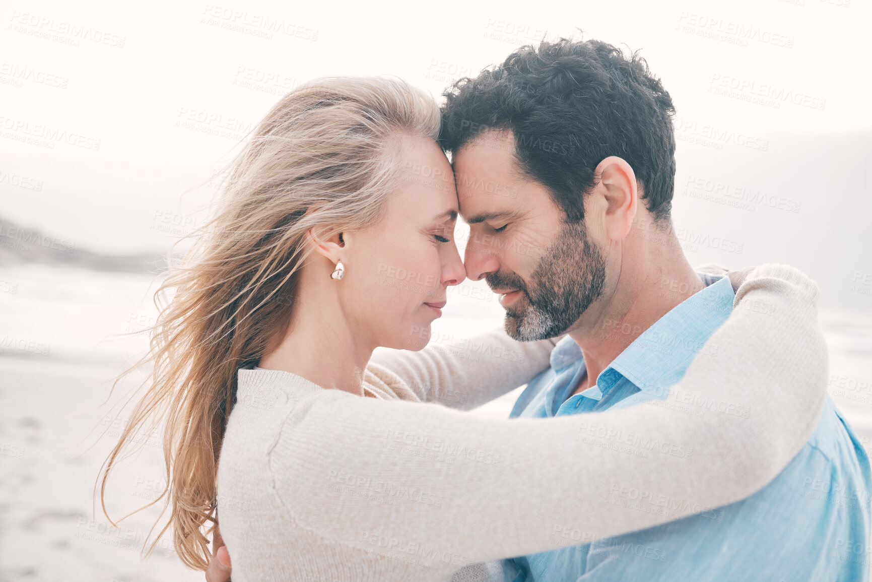 Buy stock photo Love, touching face and couple at beach for holiday, vacation and weekend for anniversary. Intimacy, marriage and loving mature man hugging woman for bonding, quality time and romantic trip by ocean