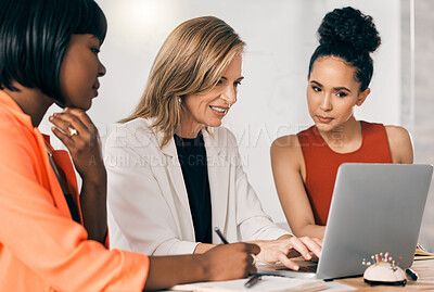 Buy stock photo Shot of a group of businesspeople using a laptop together at work