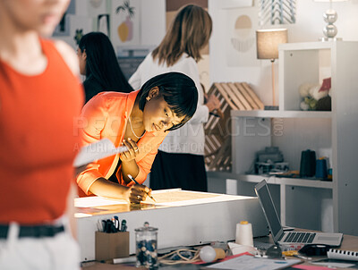 Buy stock photo Shot of a businesswoman working on designs at a workshop
