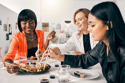 Buy stock photo Shot of a group of female friends enjoying sushi together