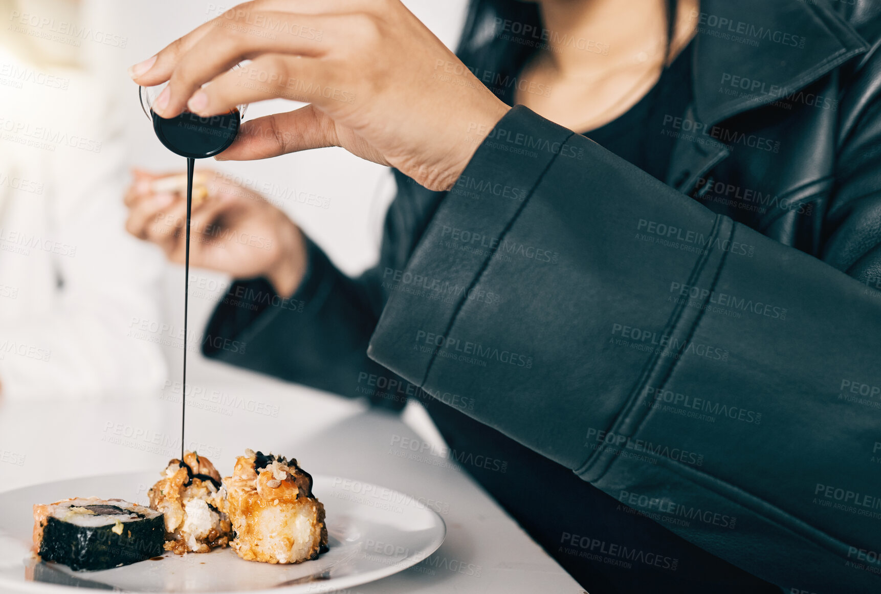 Buy stock photo Sushi, hand of person or pour soy sauce on pieces for flavor, taste or gourmet meal in office. Woman, teriyaki or Japanese cuisine at table for takeaway food or high quality catering in business