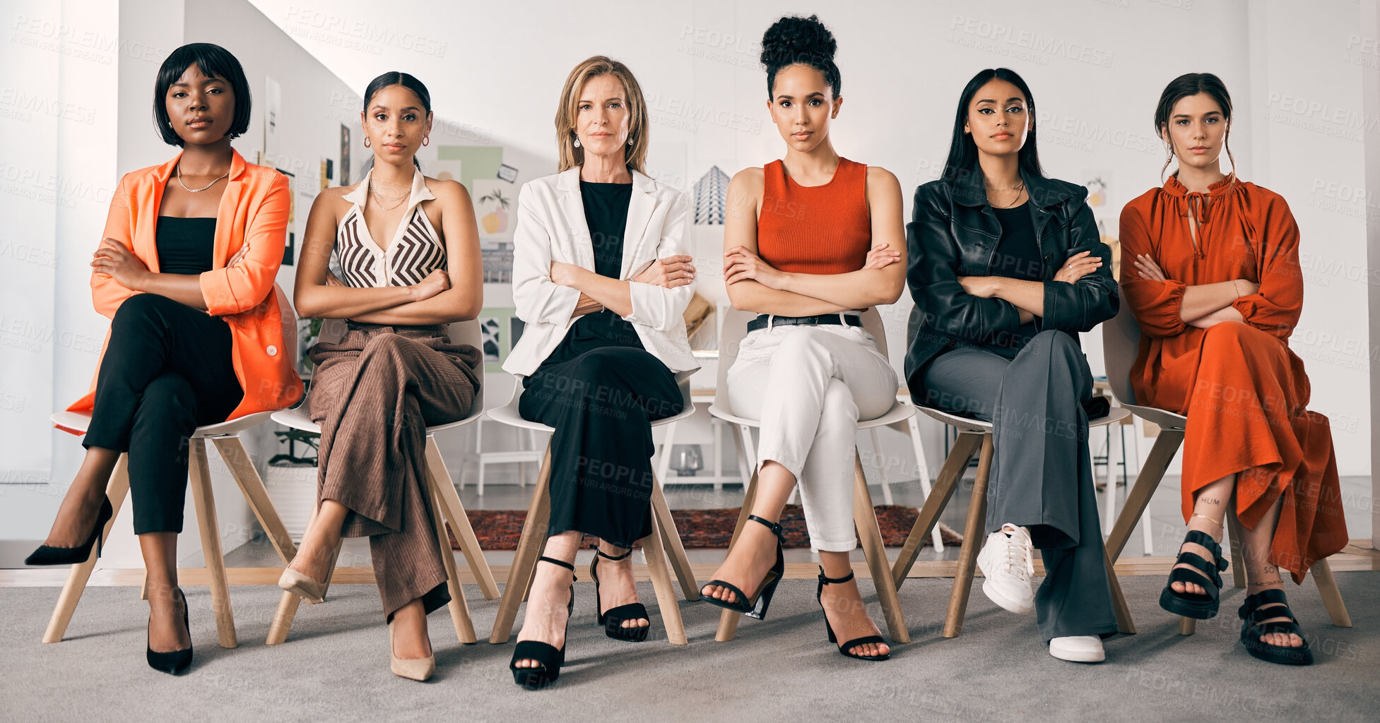 Buy stock photo Shot of a group of businesswomen sitting in a row in an office at work