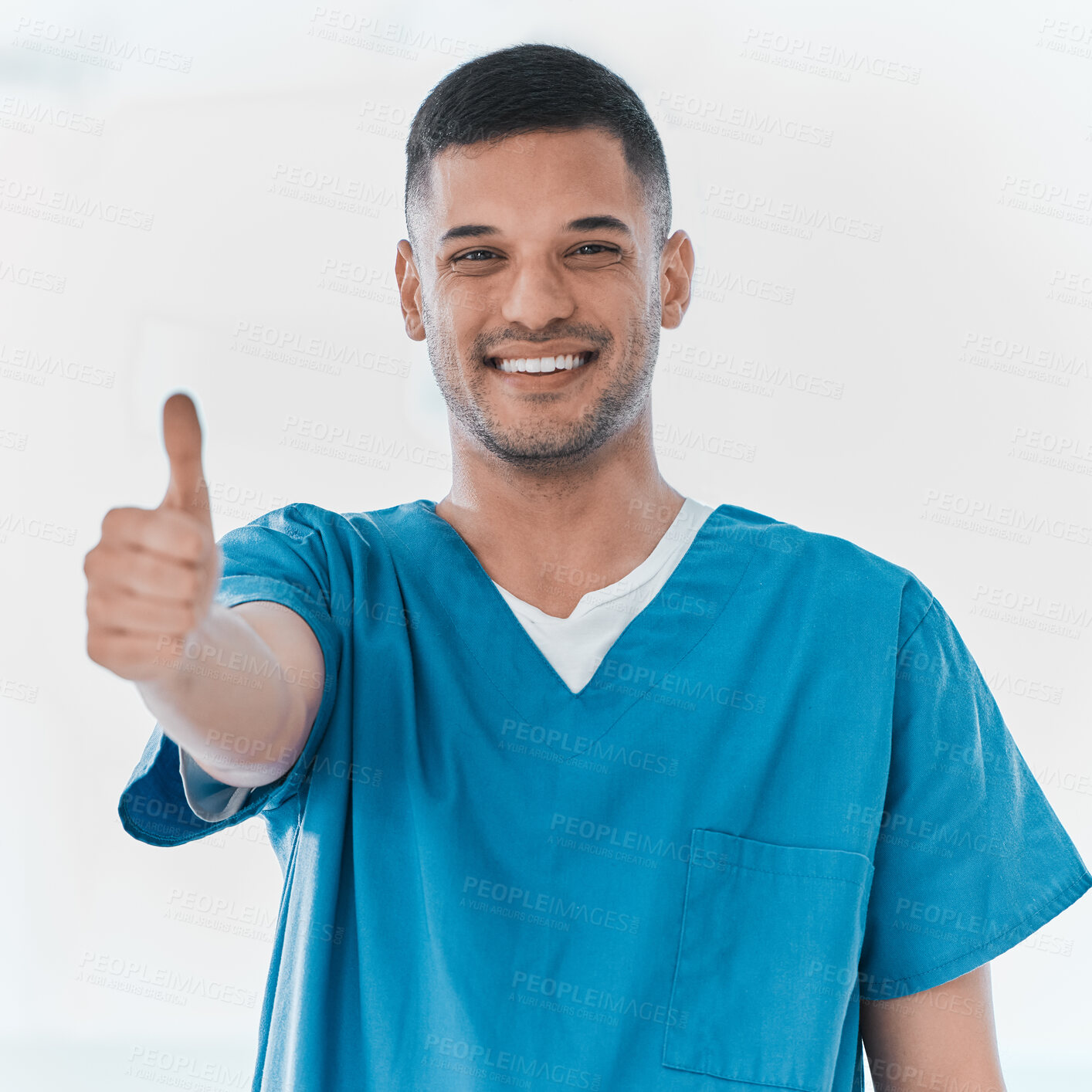 Buy stock photo Portrait of a young doctor showing thumbs up in a hospital