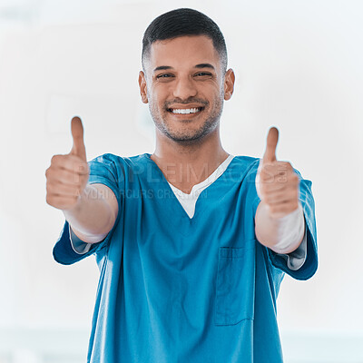 Buy stock photo Portrait of a young doctor showing thumbs up in a hospital
