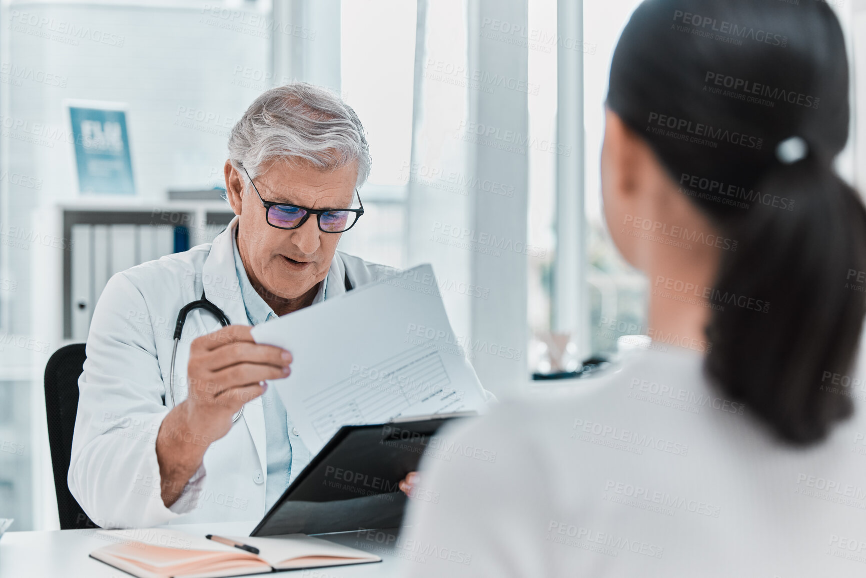 Buy stock photo Mature doctor, patient and report in consultation for healthcare, checkup results or advice. Medical professional, woman and clipboard in appointment for help, question and insurance form in hospital