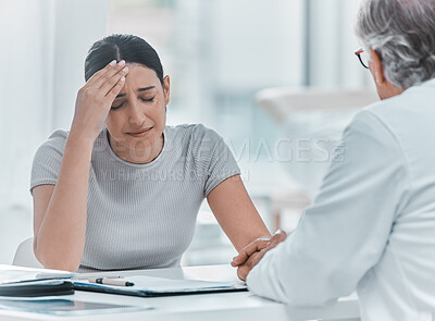 Buy stock photo Shot of an attractive young woman sitting and holding her doctor's hand while he comforts her in the clinic