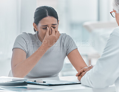 Buy stock photo Shot of an attractive young woman sitting and holding her doctor's hand while he comforts her in the clinic