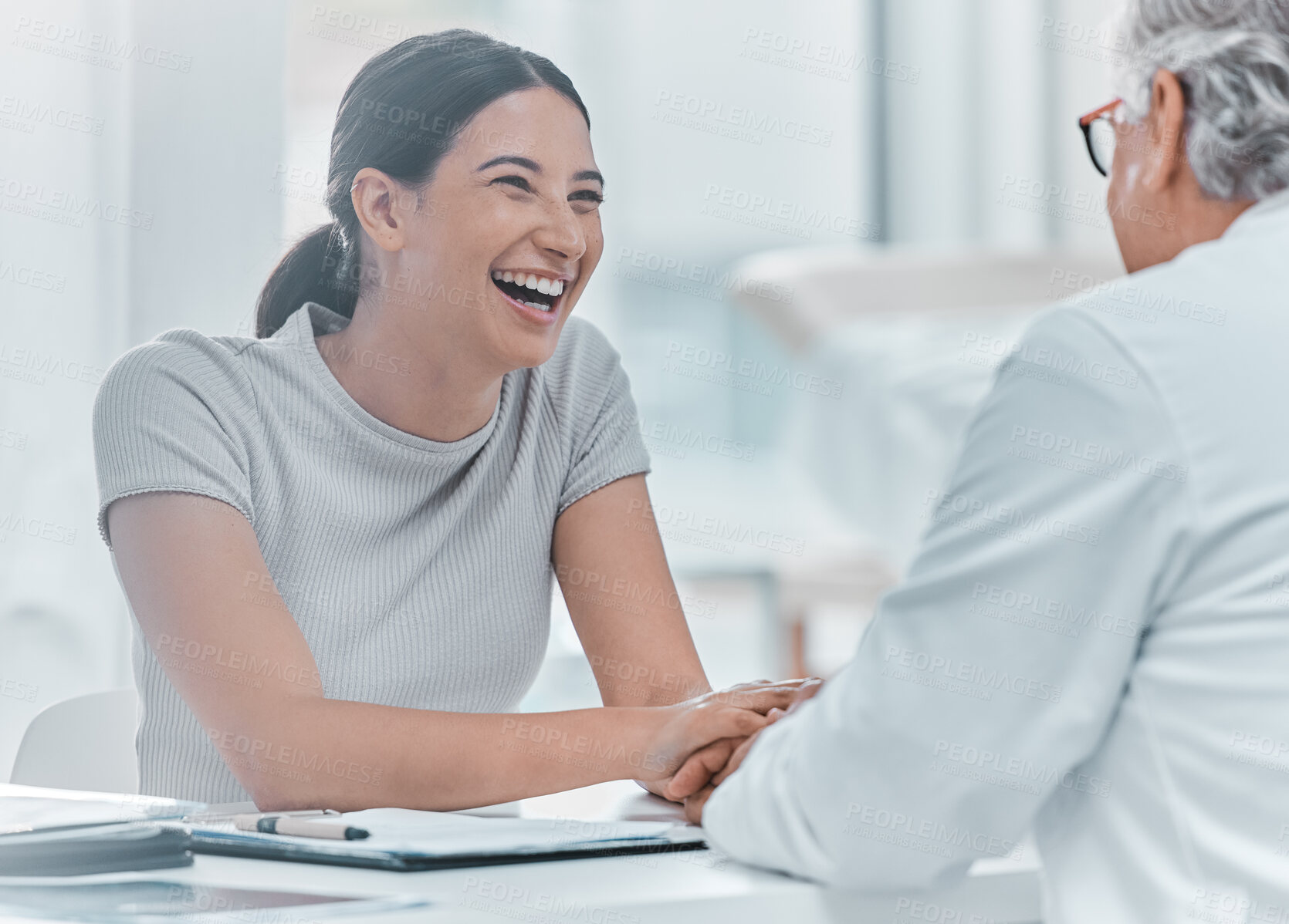 Buy stock photo Doctor, happy woman and holding hands to support patient in consultation for health or good results. Medical professional, mature man and comfort for trust, laugh or thank you in hospital appointment